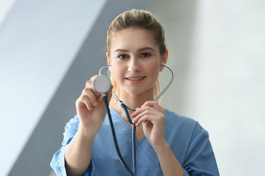 Young medical assistant with stethoscope in clinic
