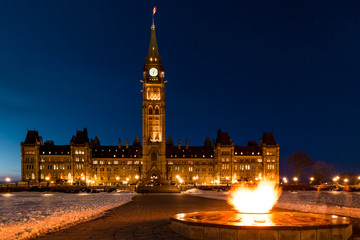 Fototapeta na wymiar Parliament of Canada in Ottawa and Centennial Flame Winter