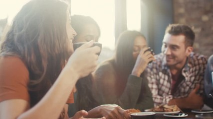 Happy group of friends chatting & having drinks in city coffee shop - Powered by Adobe