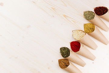 Colorful powder spices  on white wooden board with copy space.