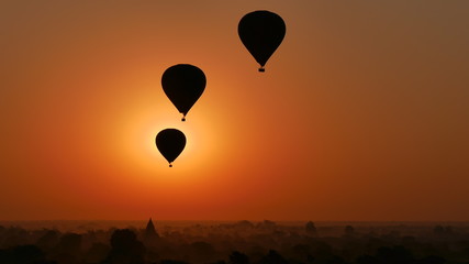 Hot air balloons over temple landscape at dawn in bagan, myanmar