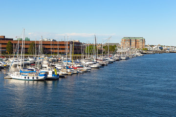 Fototapeta na wymiar Boston city harbor in summer, USA. Yachts moored at docks of Charles River harbor.