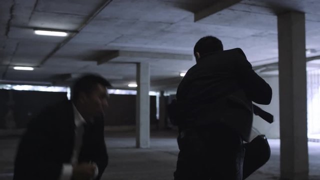  Asian gangster fighting in dark parking lot with members of a rival gang
