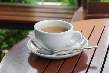 coffee  in cup  on  wood floor background