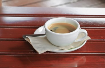 coffee  in cup  on  wood floor background