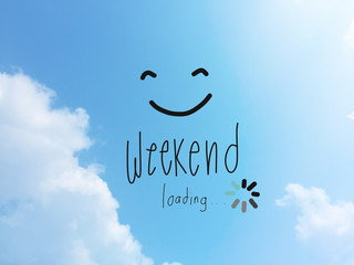 Weekend loading word and smile face on blue sky