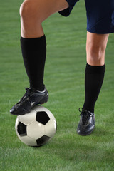 Female Soccer Player Stepping on Ball