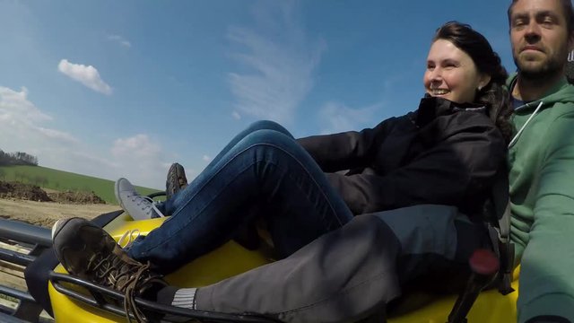 Fun on the bobsleigh track.
Young couple enjoying bobsled rides.
