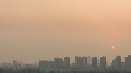 Fototapeta na wymiar High angle horizontal building shot of sunset in beijing on a foggy day