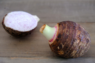 taro root  and slice on the wooden table