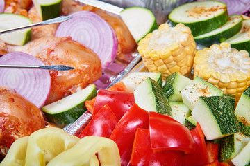 Marinated meat and vegetables prepared for grilling