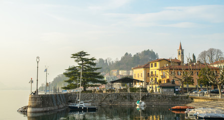 Scene of small town with dock and lake in Italy