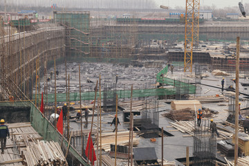 18 Dec,2014 Beijing. Work activity on a construction site in City with cranes and workers,building...
