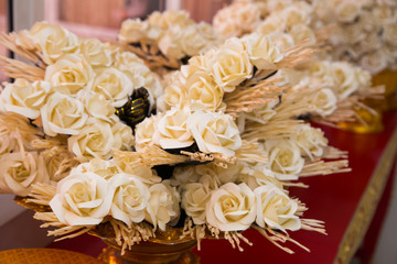 kind of wood flowers to be placed on the site of cremation in golden tray in front of crematory
