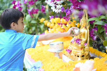 Little boy playing water gun  splash in Songkran water festival in Thailand