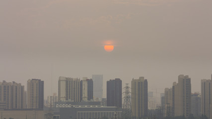 Naklejka premium High angle horizontal building shot of sunset in beijing on a foggy day