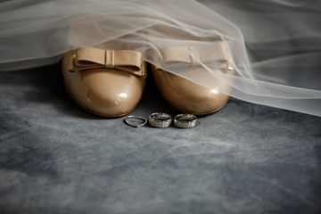 Bridal shoes, wedding rings, engagement ring and bride's veil -ideal accessories for wedding day