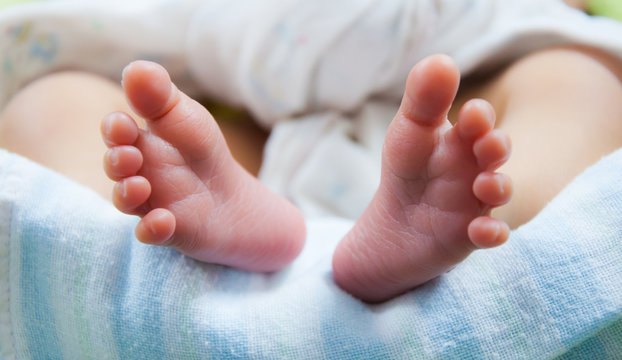 Close up tiny newborn feet