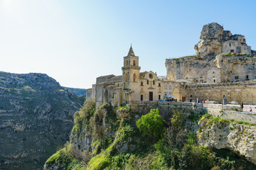 Fototapeta na wymiar The ancient ghost town of Matera (Sassi di Matera) in beautiful sun shine with blue sky, southern Italy