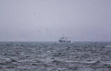 boat on the river and waves during a storm