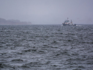 boat on the river and waves during a storm