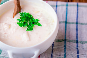 Cream soup in white bowl. Close up.