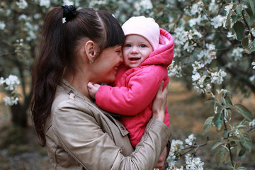 Obraz premium Mother with baby in summer garden sunny day forest tree