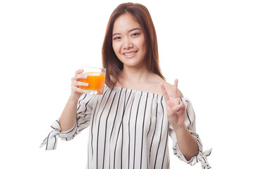 Young Asian woman show victory sign drink orange juice.