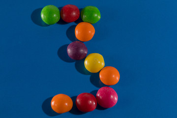 Image of colorful and tasty candies skittles figue postcard