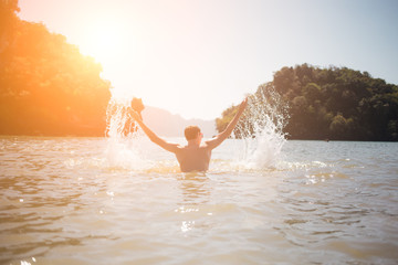 Man arms raised in sea