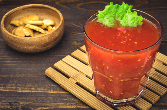 smoothie from tomatoes with croutons/tomato juice with croutons on a wooden background