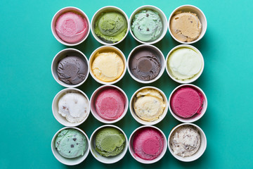 Top view Ice cream flavors in cup on green background