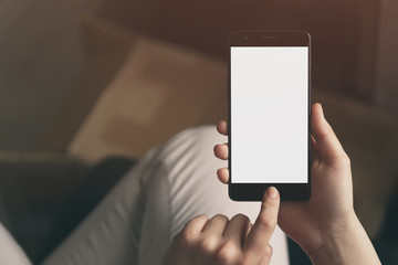 young female teen hand using smatphone sitting at the table closeup, shallow focus with copy space