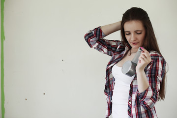 Girl doing repairs in the apartment