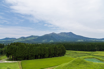 Mount Aso volcano and green field in Kumamoto, Japan