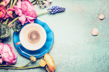 Cup of coffee and summer  flowers from garden on blue vintage shabby chic background, top view, copy space