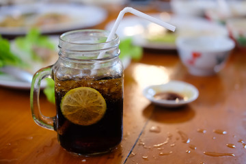 Glass of cola with lemon slice