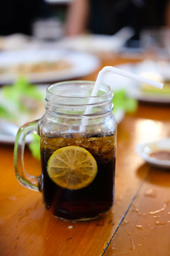 Glass of soft drink with lemon slice