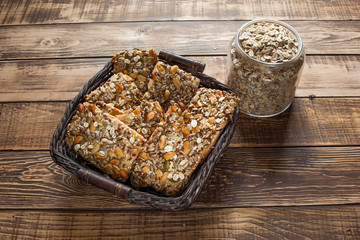 Baked oats with dry fruits, a jar with oats on wooden table