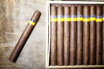 Large box of Cuban cigars on a wooden table