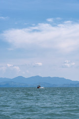 Longtail boat on the sea with island background in Satun, Thailand