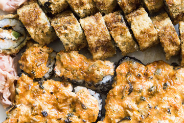 Sushi rolls with salmon, black caviar and sesame close-up macro shot