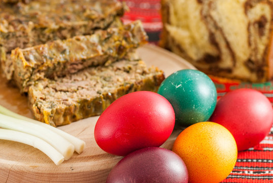 traditional romanian easter dishes colored eggs sponge cake and meat cake 