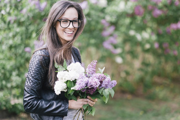 Natural young sexy woman with lilac flowers. Looks like film photo