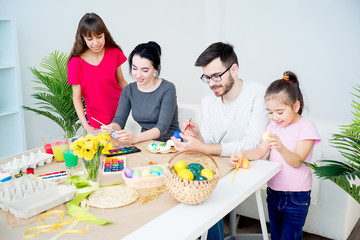 Family painting eggs