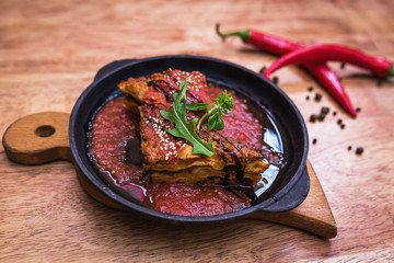 Lasagna bolognese in a hot frying pan