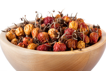 Dried rosehips in wooden bowl