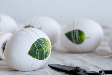 Easter eggs Decorated with leaves on textile background. Concept for your design