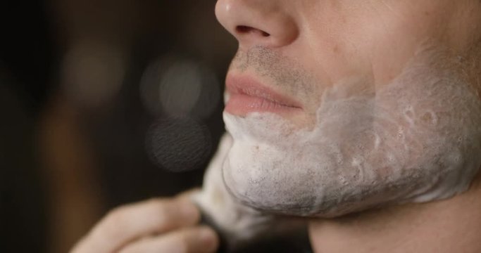 Close up of man being prepared for a traditional shave in barber shop