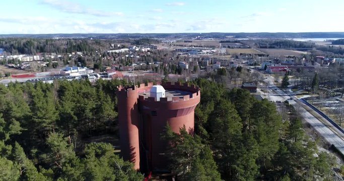Halikko watertower, Cinema 4k landing tilt aerial view of Halikko water tower, on a sunny spring day, in Salo, Finland